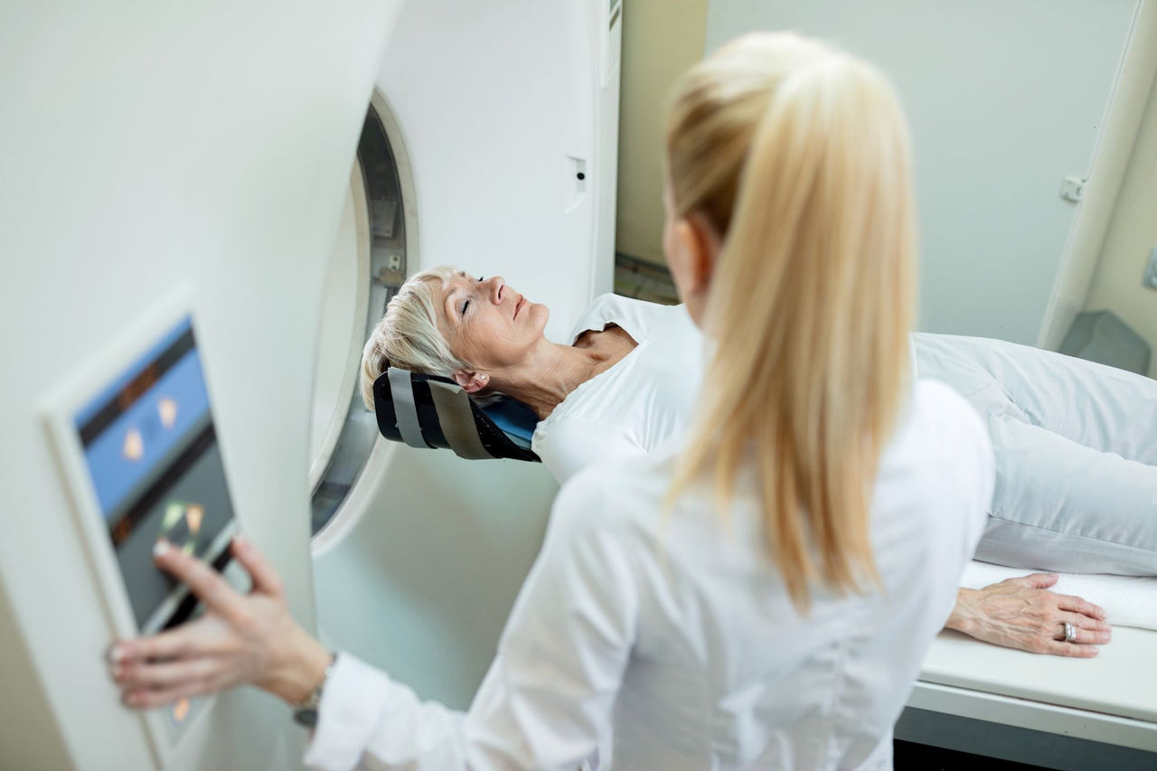   Woman undergoing MRI scan with technician